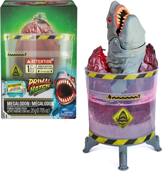 Primal Hatch Megalodon shark bursting from its egg inside the hazard-striped lab tank
